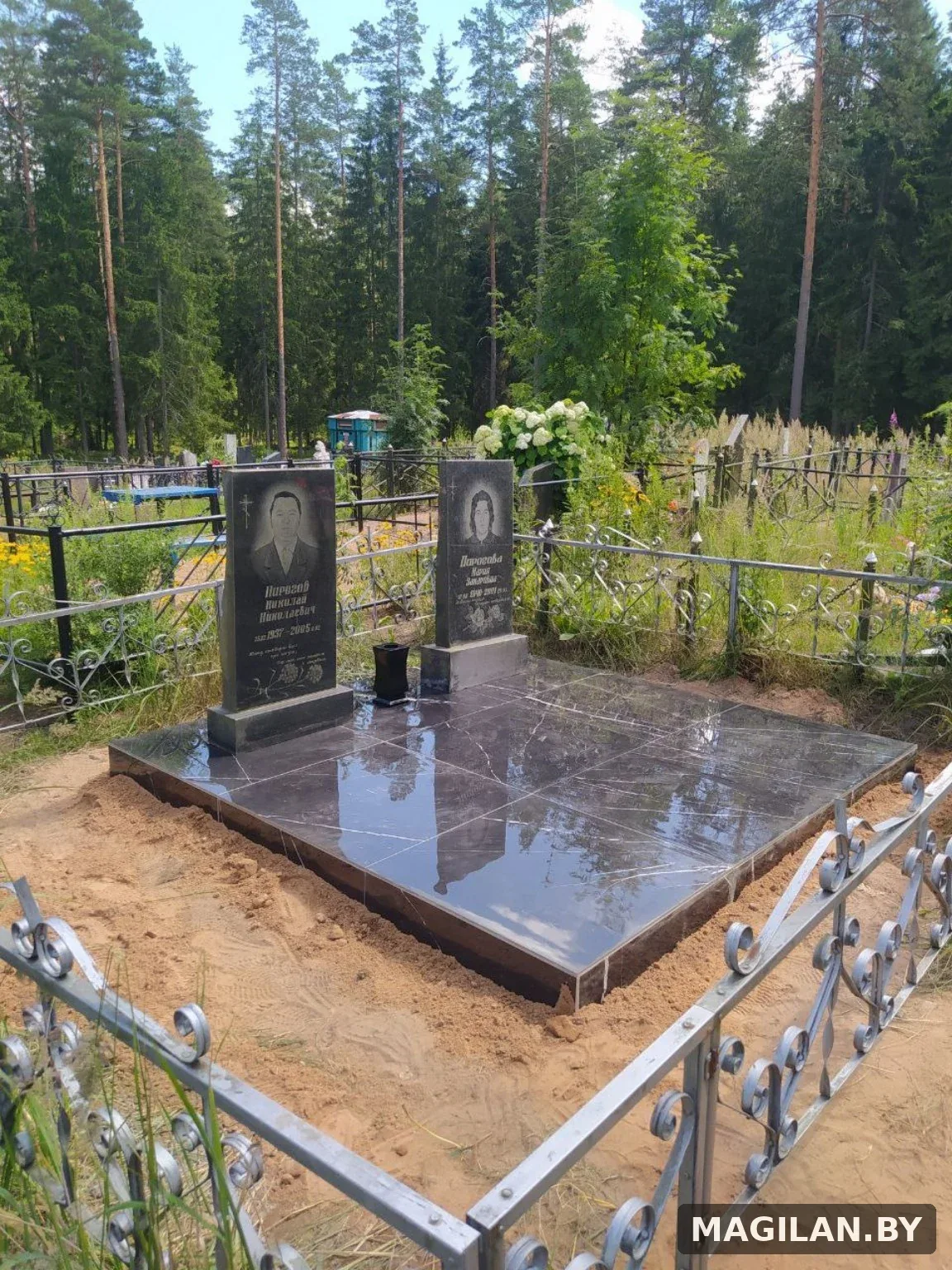 Два памятника на общей тёмной плиточной площадке в Минской области